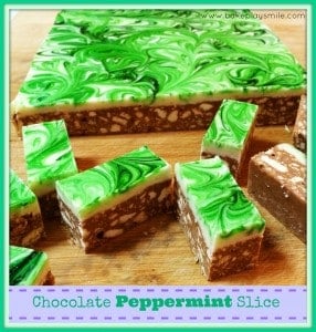 A chocolate slice topped with white chocolate and swirls of green through it.
