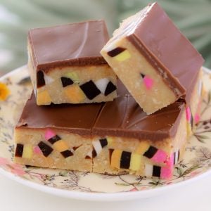 A stack of licorice allsort slice pieces on a floral plate