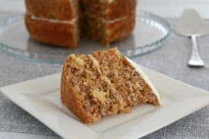 A serve of iced carrot cake on a square white plate