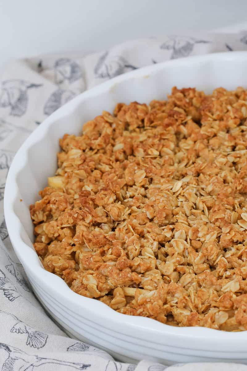 A crunchy oat and apple crisp in a baking dish. 
