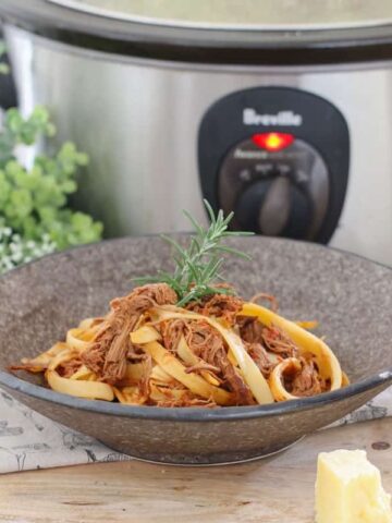 This Slow Cooker Italian Beef Ragu Pasta has a beautiful, rich tomato based sauce, beef that literally melts in your mouth, and of course, a good sprinkling of parmesan cheese. This is winter comfort food at it's very best!