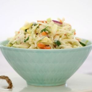 A pale blue bowl filled with Apple Coleslaw