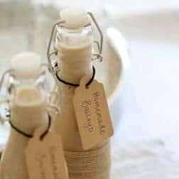 Two filled bottles with handwritten labels attached.