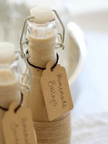 Two filled bottles with handwritten labels attached.