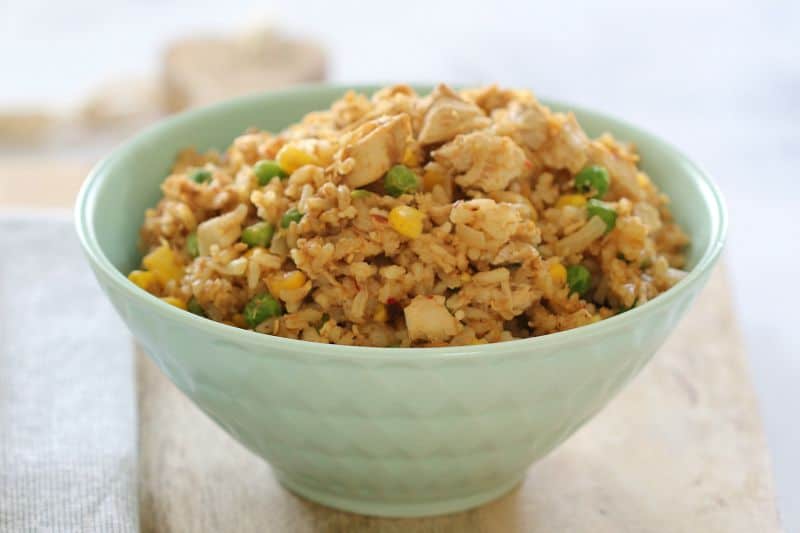 Fried rice with chicken, corn and peas in a bowl