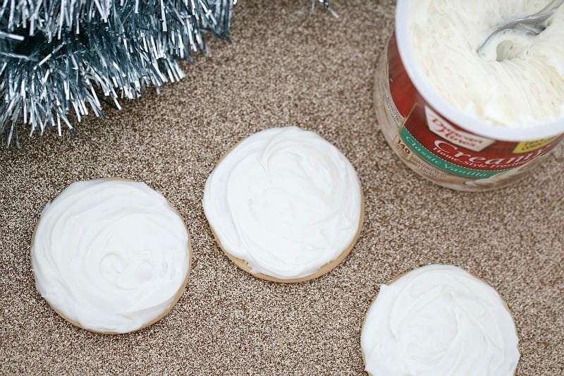 Plain biscuits on a bench iced with white frosting
