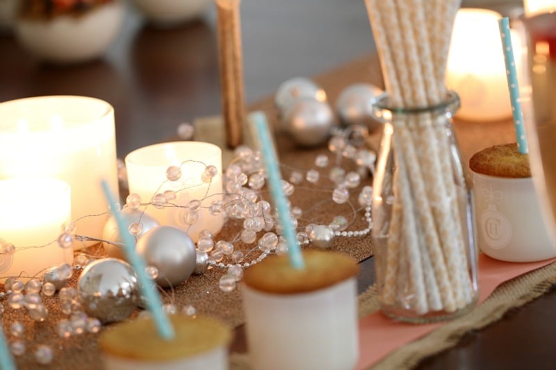 Snickerdoodle cookies on jars with white and silver Christmas decorations in the background