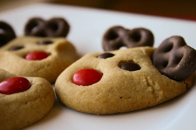 Biscuits baked with Smarties for a face, and chocolate coated pretzels for antlers