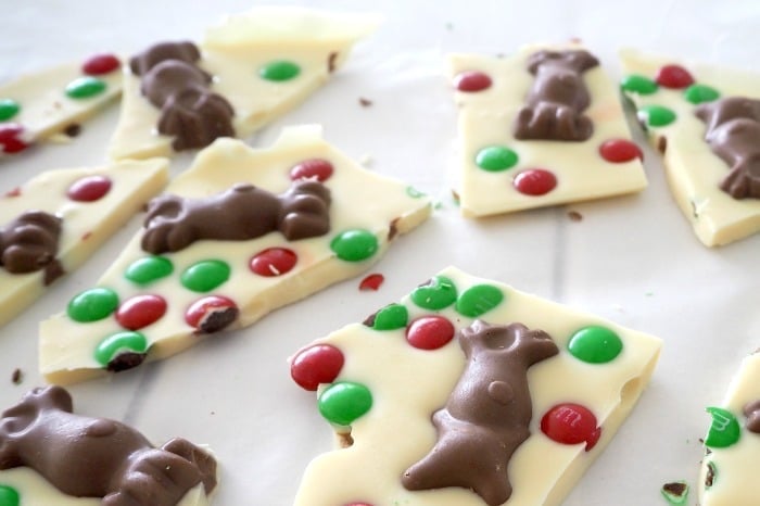 Wedges of white chocolate bark, decorated with red and green M&M\'s and chocolate reindeer