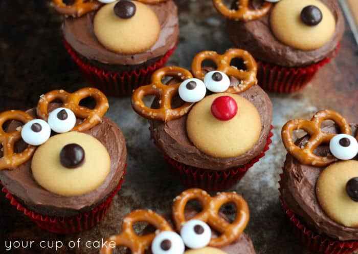 Chocolate cupcakes iced and decorated with lollies and pretzels to resemble reindeer faces