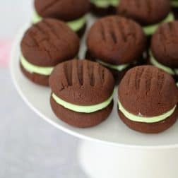 A plate of chocolate cookies sandwiched together with mint cream filling