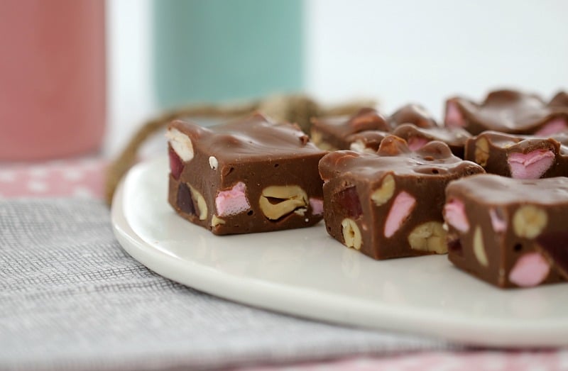 A close up of Rocky Road Fudge squares on a white serving platter