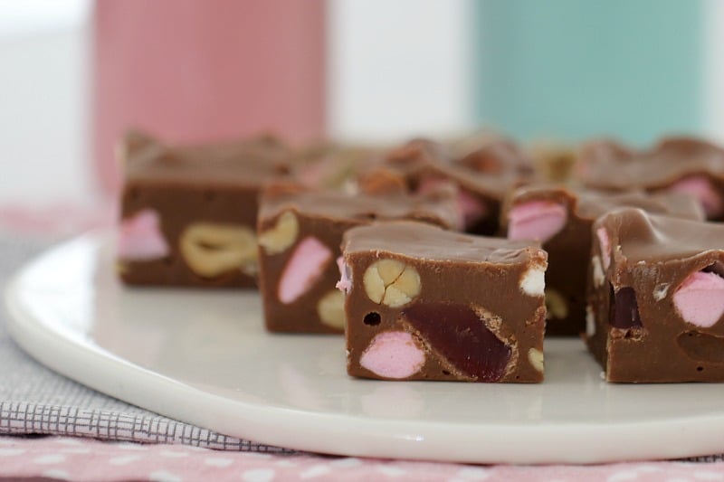 A side view of squares of chocolate Rocky Road, filled with Turkish Delight, marshmallows and nuts