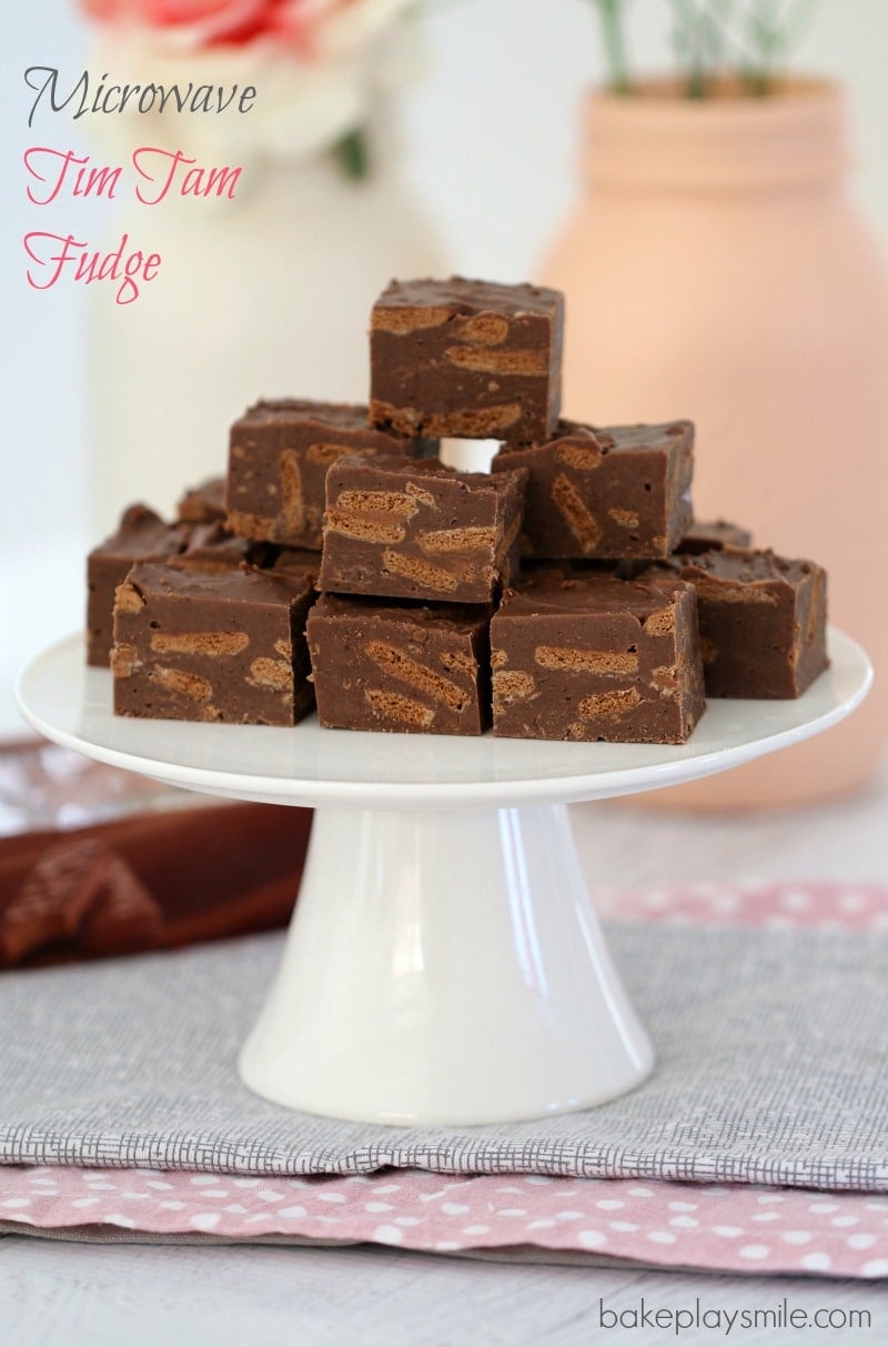 A white cake stand loaded with squares of Tim Tam fudge