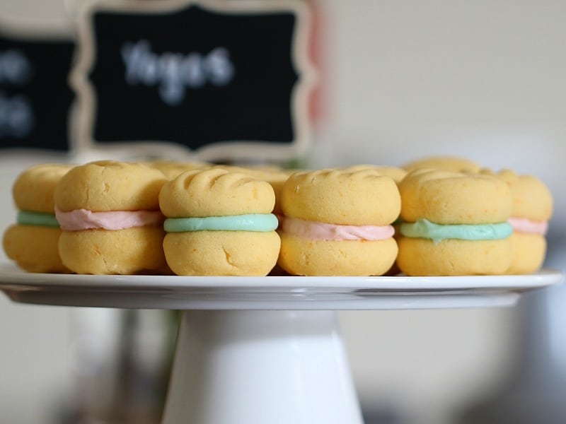 A side view of Yo Yo\'s sandwiched together with lightly coloured cream icing.