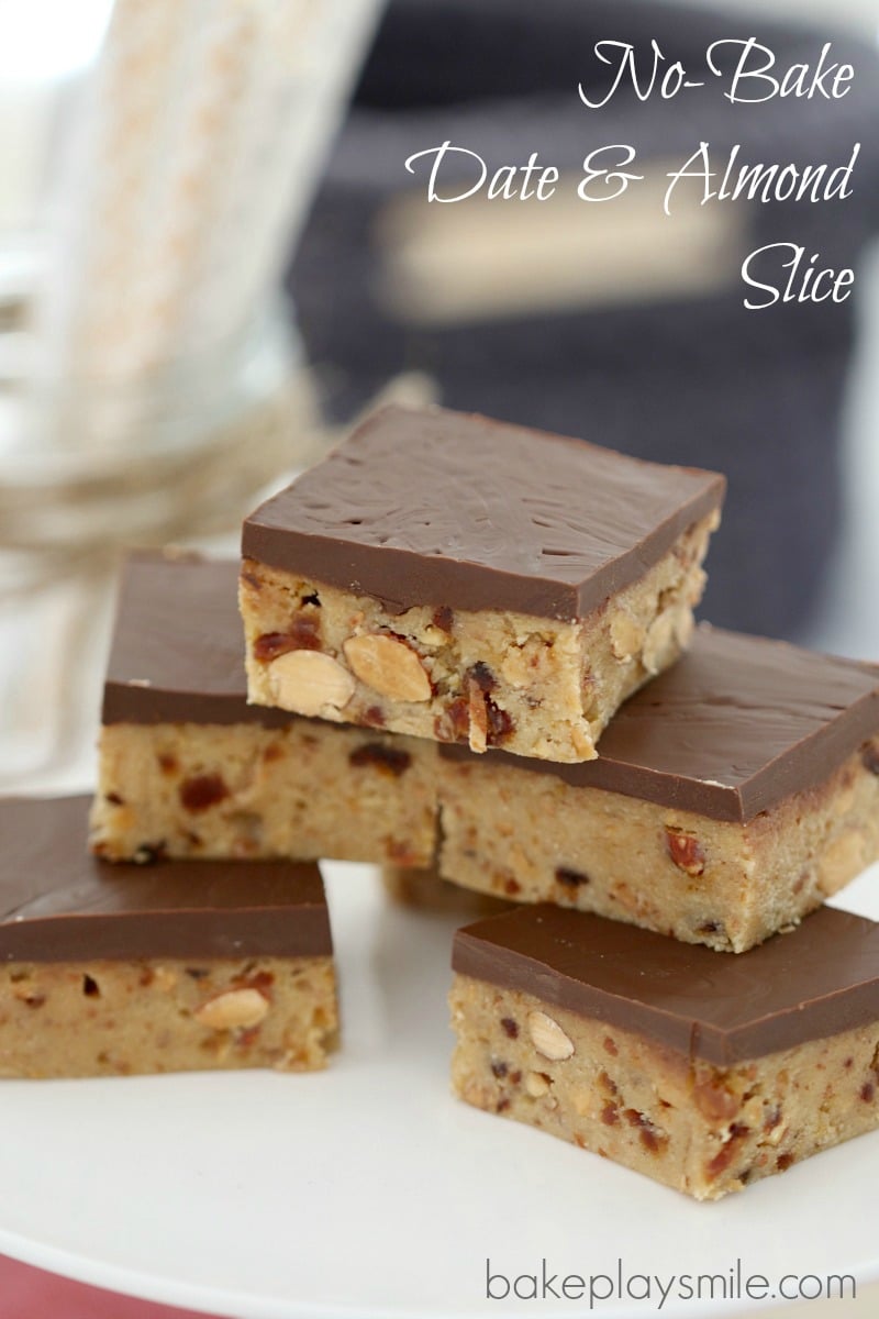 Squares of a chocolate topped slice stacked up, showing a filling of chopped dates and almonds