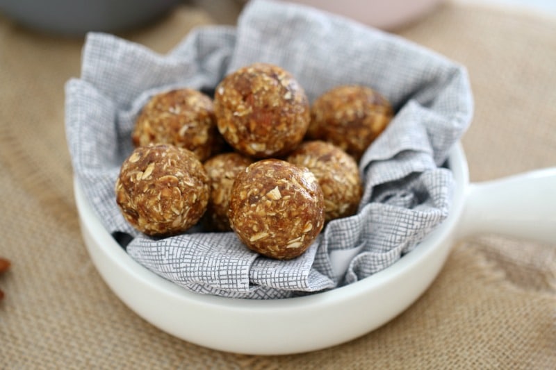 A pile of energy bliss balls on a napkin in a small bowl
