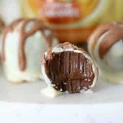 A close up of a half eaten chocolate cheesecake ball