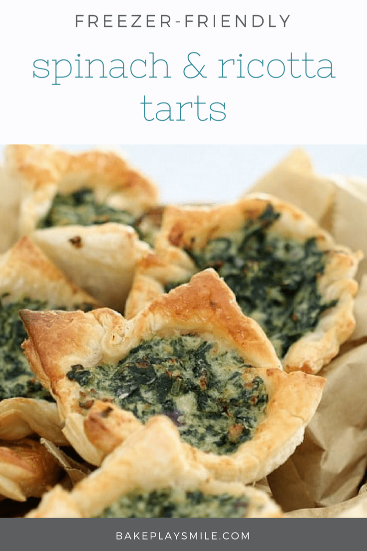 A pile of golden pastry square tarts filled with spinach and ricotta 