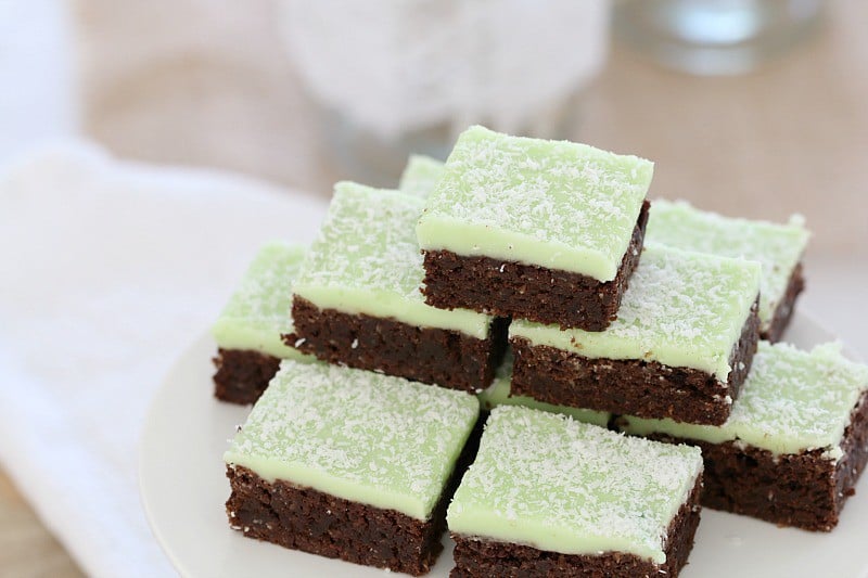 Pieces of chocolate slice with a mint icing, stacked on a plate