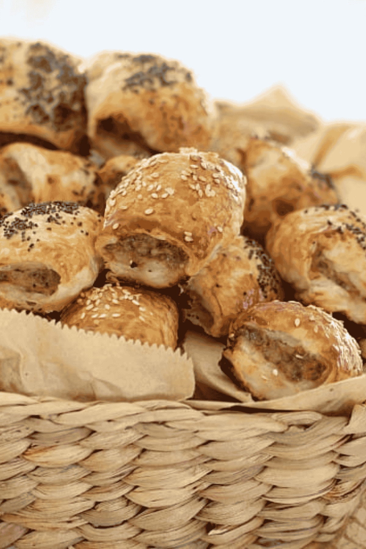 Mini lamb sausage rolls in a basket.