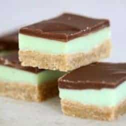 Three pieces of slice made with a baked crumb base, a green minty flavoured layer and then topped with a layer of chocolate.
