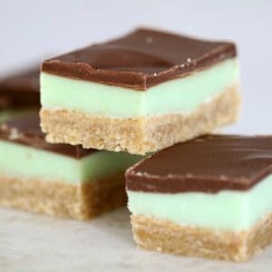 Three pieces of slice made with a baked crumb base, a green minty flavoured layer and then topped with a layer of chocolate.