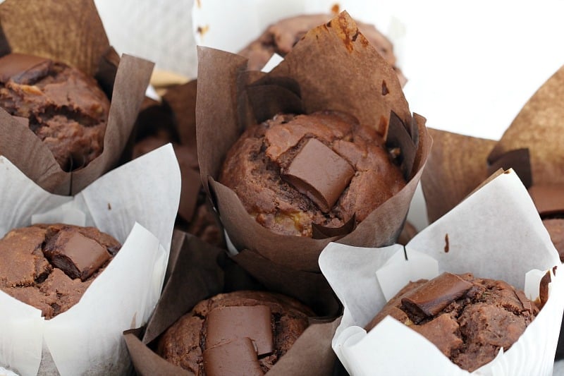 A basket filled with double chocolate muffins in baking paper