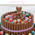 A chocolate easter cake hack with chocolate finger biscuits, easter eggs and Malteser bunnies.