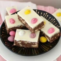 A plate of hedgehog slice decorated with white icing and pink and yellow sweets