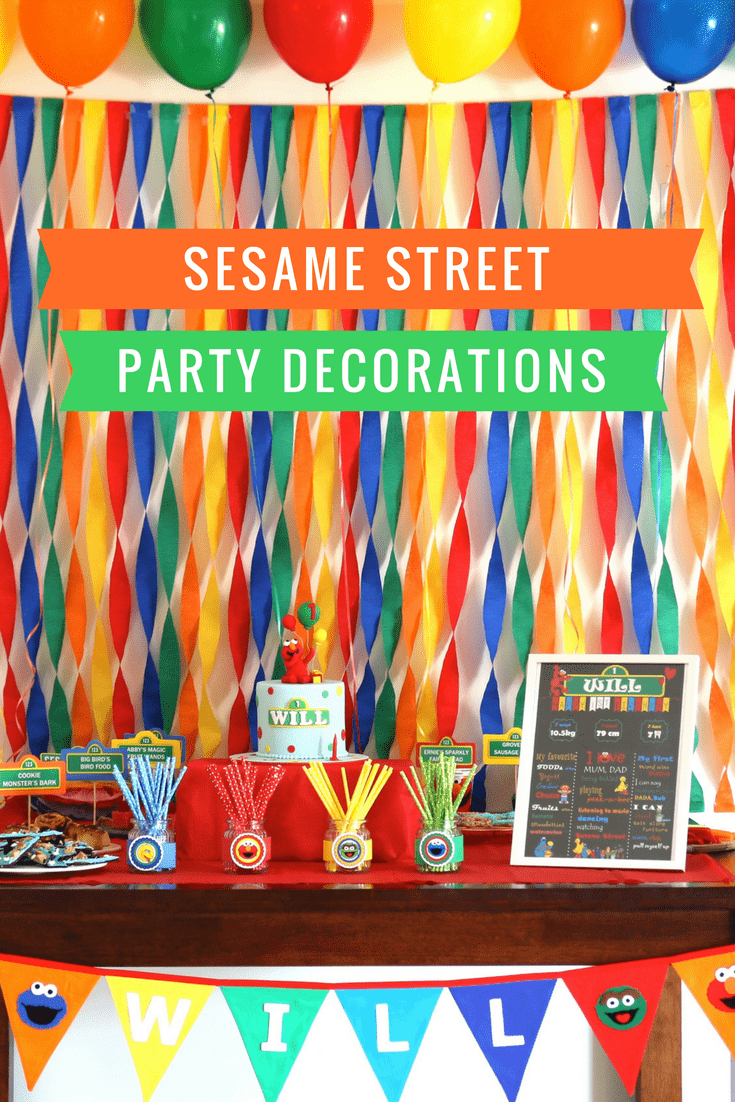 Rainbow coloured streamers and colourful party food showing Sesame Street party decorations