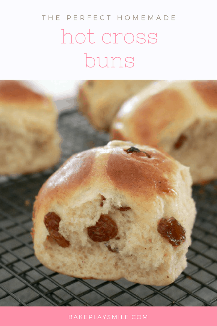 A close up of Hot Cross Buns with sultanas sitting on a wire tray