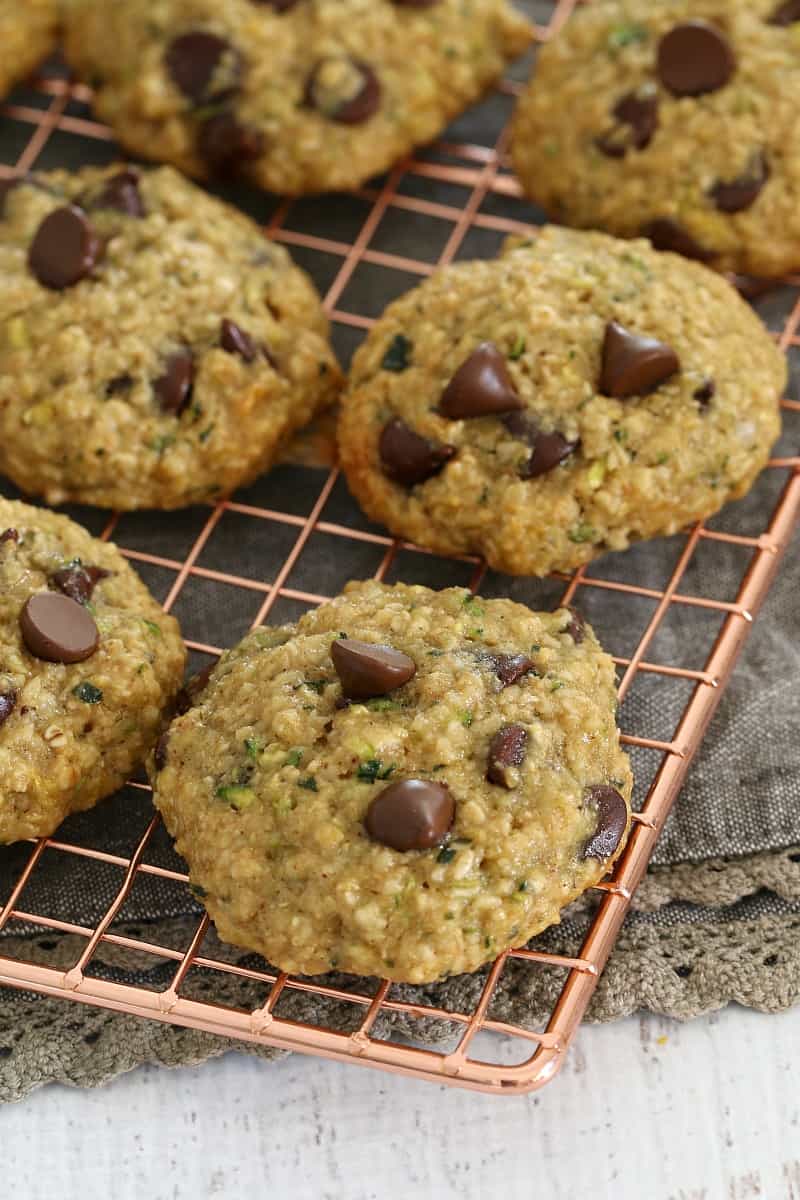 A copper wire tray of cookies filled with chocolate chips, oats and zucchini