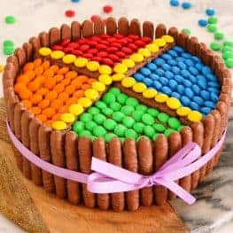 This M&Ms chocolate cake is the perfect birthday cake! It's so simple to make and looks amazing. Decorated with chocolate biscuits, frosting & M&Ms... this is sure to be a hit!