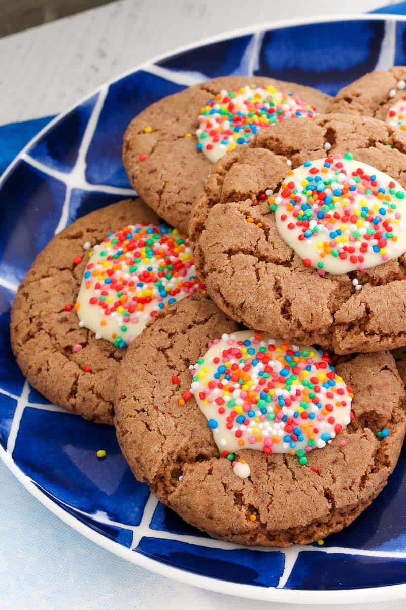Milo biscuits with white chocolate and sprinkles on a plate. 
