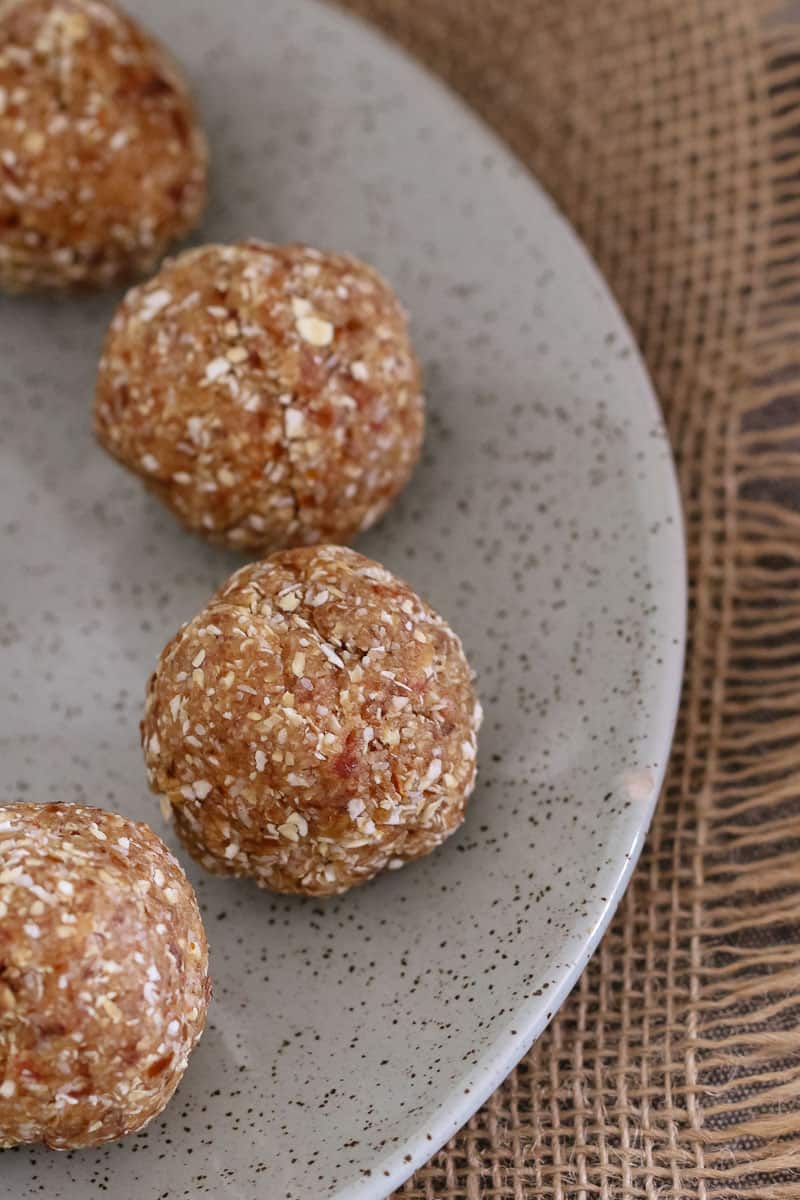 A close up of protein balls on a plate. 
