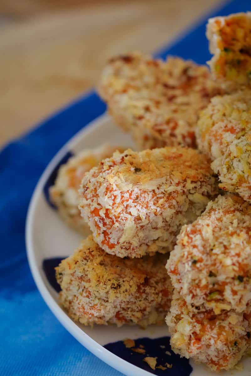 Bread crumbed baked nuggets stacked on a plate