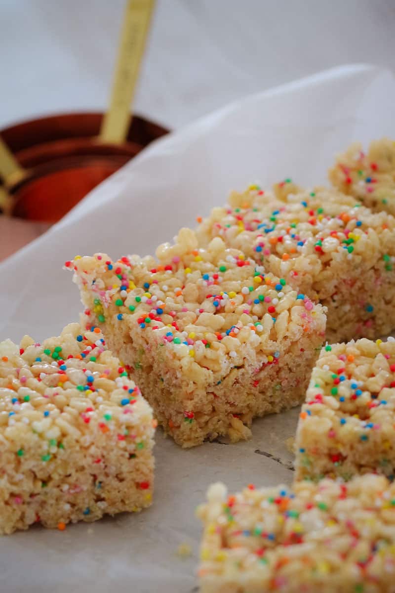 Slices covered in sprinkles on a piece of baking paper
