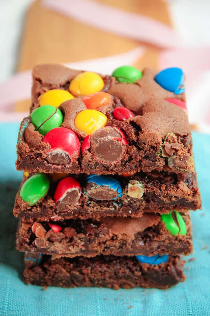Front view of stack of brownies topped with coloured M&Ms