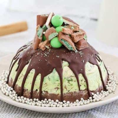 A delicious triple layer Christmas peppermint ice-cream cake! Chocolate, vanilla and mint flavoured ice-cream layers packed full of cookies, chocolates and more!