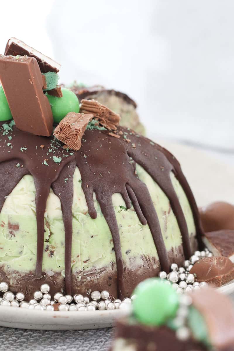 A chocolate and mint Christmas ice cream pudding cake. decorated with peppermint chocolates.