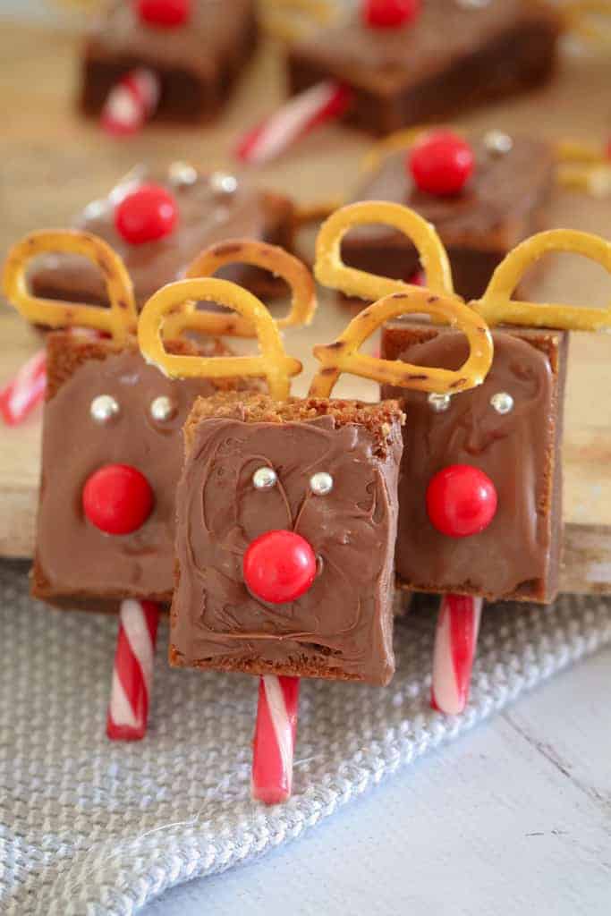 Chocolate brownies decorated with candy canes, pretzels, chocolate and jaffas to resemble reindeer.