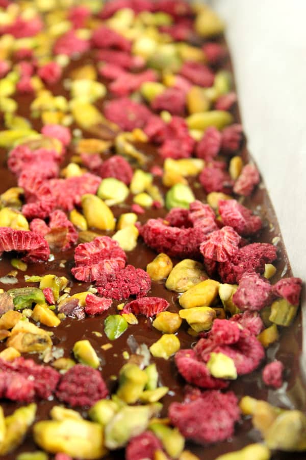 Close-up of a tray of pistachio & raspberry dark chocolate bark