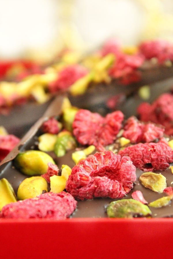 Close-up of pistachio & raspberry dark chocolate bark wedges.