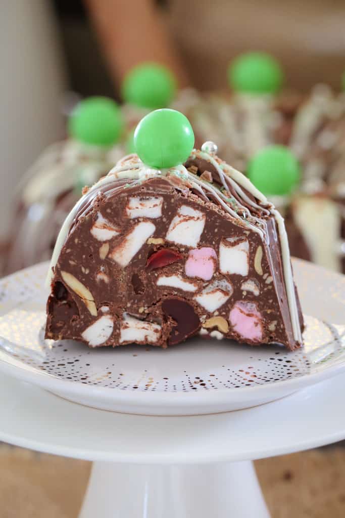 A slice of mint rocky road Christmas wreath on a white plate