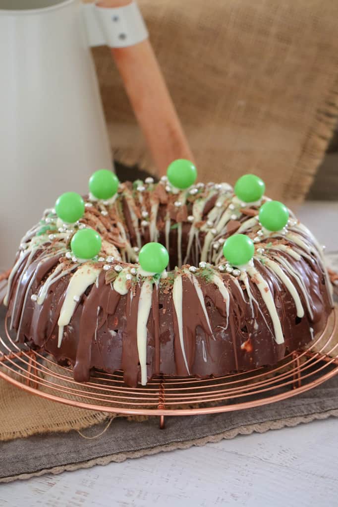 White and milk chocolate drizzled over a Mint Rocky Road Christmas Wreath on a copper wire tray