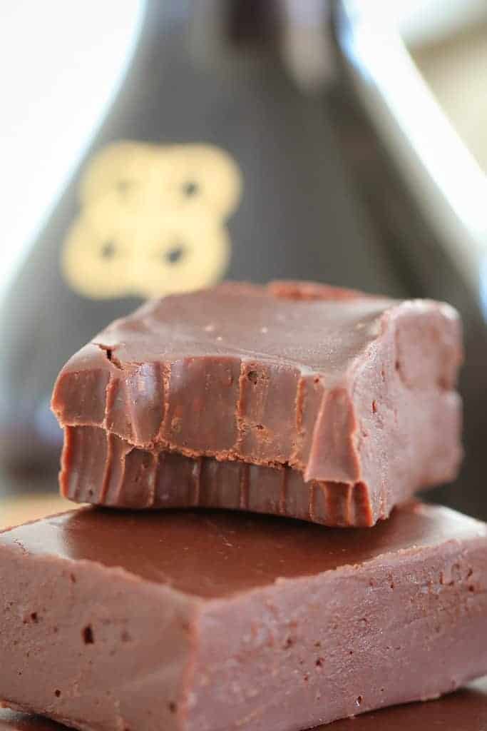 A close up of a piece of chocolate fudge that has been bitten into.
