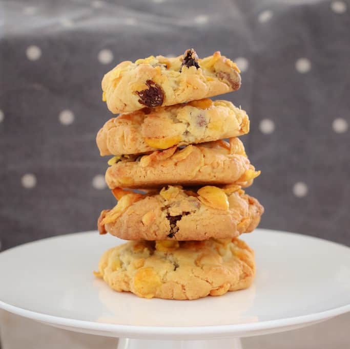 A stack of chocolate chip and sultana cookies on a round cake tray