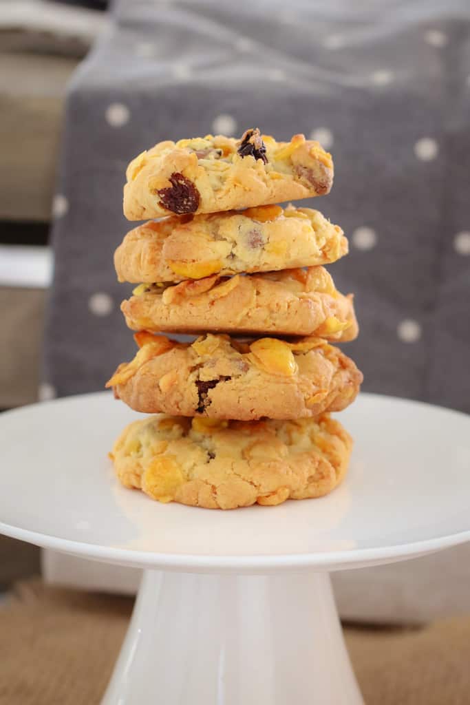 A white plate with a stack of cookies made with cornflakes and chocolate chips.