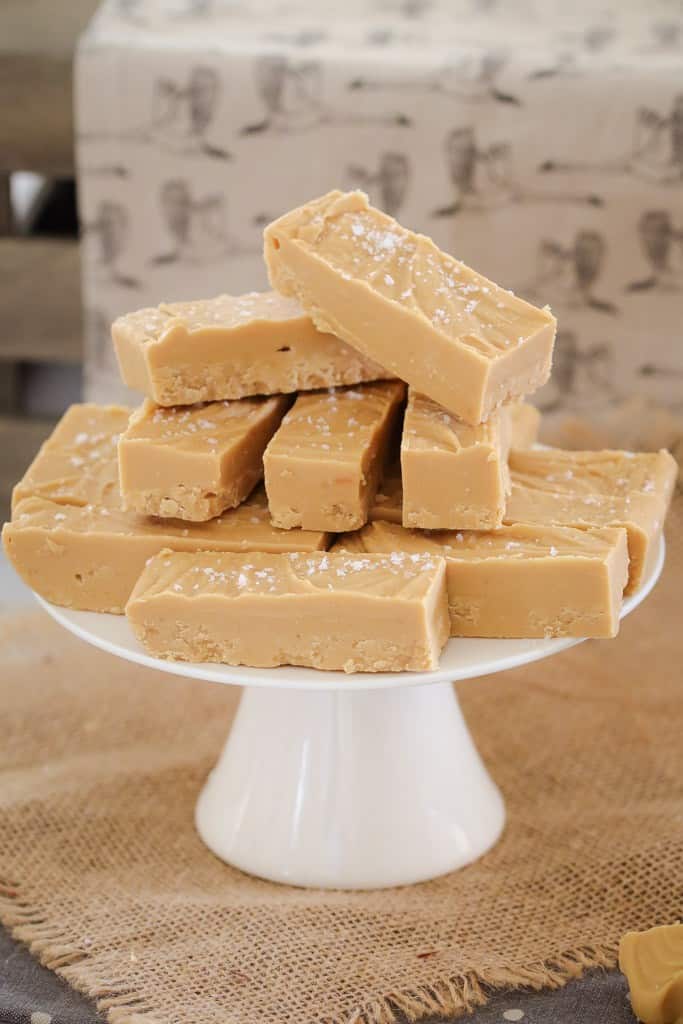 Long slices of salted caramel fudge on a cake stand. 